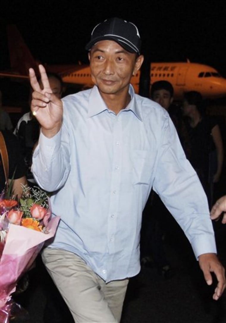In this Saturday, Sept. 25, 2010 photo, Chinese fishing boat captain Zhan Qixiong gestures as he arrives safely in Fuzhou, the capital of southeast China's Fujian Province by a chartered plane. China reiterated its demand for an apology from Japan over the detention of a Chinese fishing boat captain whose arrest plunged relations to their lowest level in years. The statement from the foreign ministry late Saturday was issued after Tokyo refused on Saturday to apologize to China following the release of the captain whose vessel collided with Japanese patrol boats near disputed islands earlier this month. (AP Photo)** CHINA OUT **